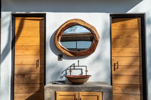 a room with two doors and a mirror on the wall at Casa Cecilia Lodging House in Oaxaca City