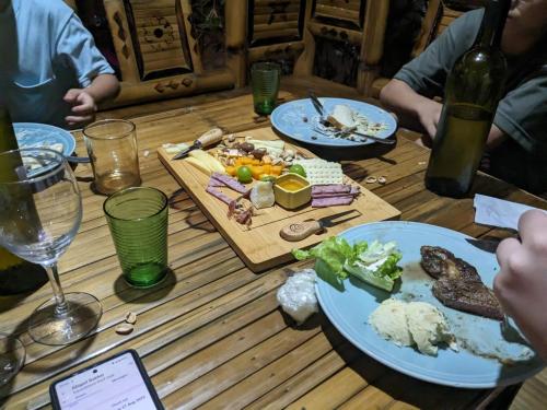 a wooden table with plates of food on it at Aquaventure Reef Club in Mabini