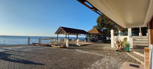 a building with a pavilion next to the ocean at Aquaventure Reef Club in Mabini
