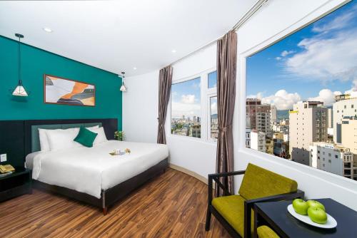 a hotel room with a bed and a large window at Golden Star Hotel by THG in Da Nang
