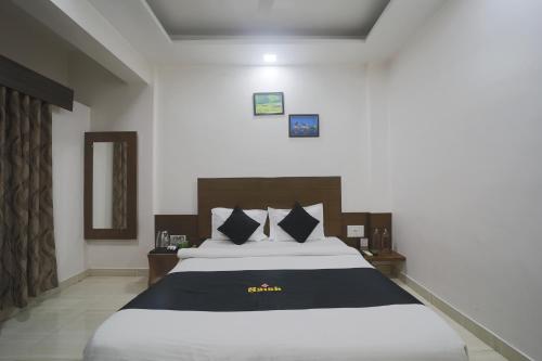 a bedroom with a large bed in a room at Saish Hotel Shirdi in Shirdi