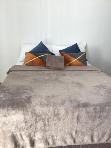 a bed with a bunch of pillows on it at 6F Balcony View Studio Mesatierra Garden Residences in Davao City