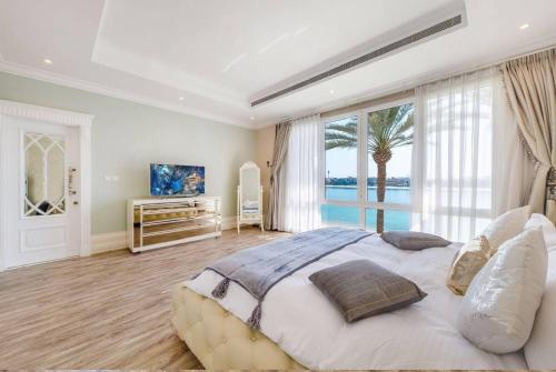 a large bedroom with a large bed and a large window at Pristine Paradise Villa In Palm Jumeirah in Dubai