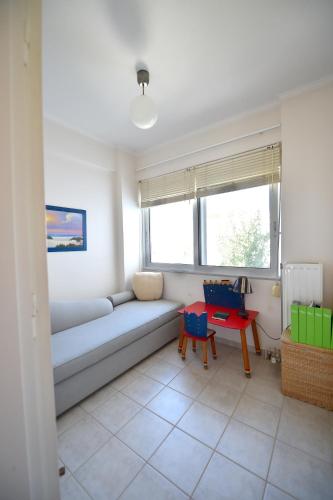 a living room with a couch and a table at Balcony of the Ionian Sea in Paralia Kanaliou