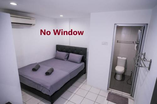 um quarto com uma cama sem um sinal de janela em Heritage Inn em George Town