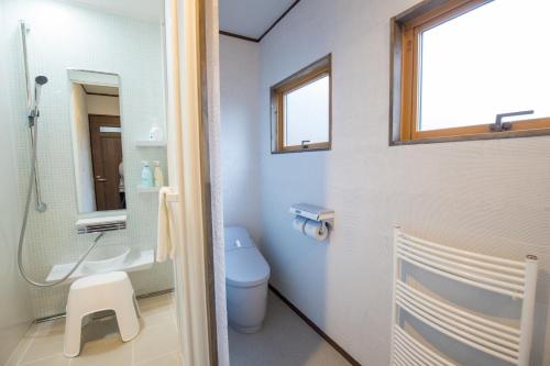 a bathroom with a toilet and a sink at KuDo's Lodge - Vacation STAY 85093 in Chikuni