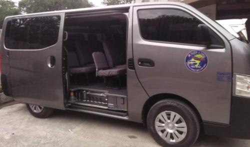 a gray van with its door open with a seat at VAN FOR RENT in Manila