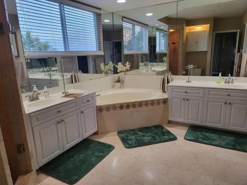a large bathroom with two sinks and a tub at Vanderbilt Beach 3br/3ba condo in Naples