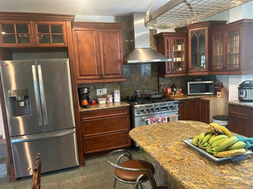 a kitchen with a table with bananas on it at Unwind Island in West Palm Beach