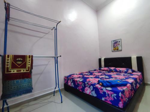 a bedroom with a bed with a canopy at NikNa Homestay Batu Rakit - WIFI in Kampong Ru Tujoh