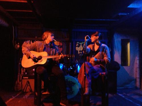 a group of three people on a stage playing instruments at Jungle Monkey Backpackers in Port St Johns