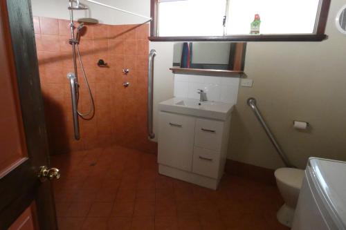 a bathroom with a shower and a sink and a toilet at Wrenwood Chalets in Augusta