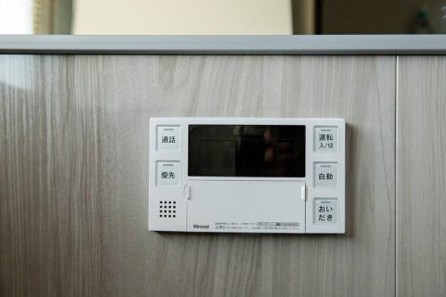 a microwave is hanging on a wall at Sea Saw in Isumi