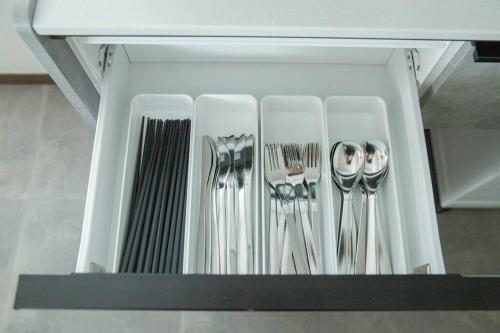 a drawer filled with utensils in a kitchen at Sea Saw in Isumi