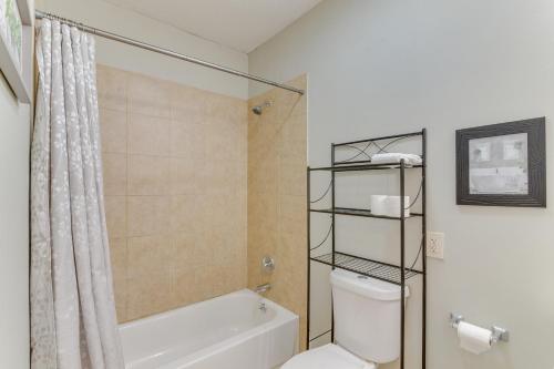 a bathroom with a tub and a toilet and a shower at Galveston Vacation Rental - Walk to the Beach! in Galveston