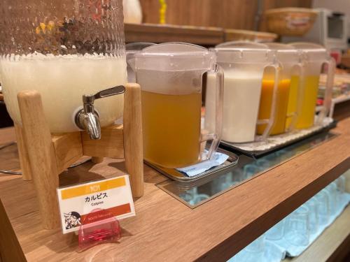 a row of glasses of beer sitting on a counter at Route Inn Grantia Naha in Naha