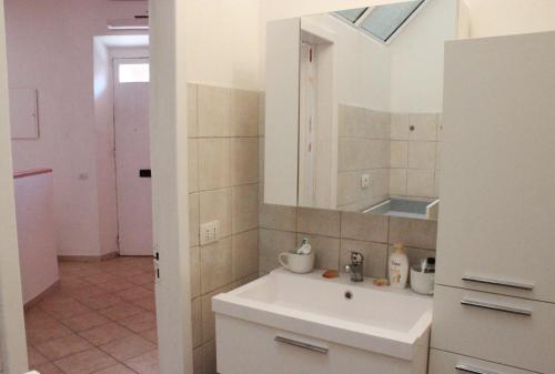 a bathroom with a sink and a mirror at La Casa Rosada Arbus in Arbus