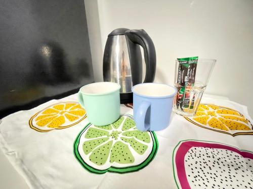 a table with two cups and orange slices on it at Lively Impact C3-C9 in Nonthaburi