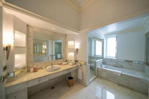 a large bathroom with a tub and a sink and a bath tub at Rajmahal Palace RAAS in Jaipur