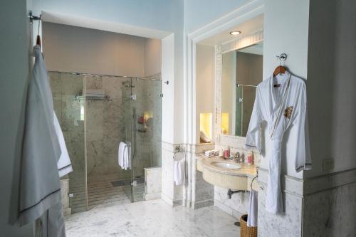 a bathroom with a sink and a shower at Rajmahal Palace RAAS in Jaipur