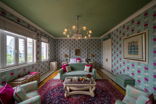 a living room with a couch and a table at Rajmahal Palace RAAS in Jaipur