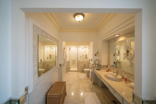 a large bathroom with two sinks and two toilets at Rajmahal Palace RAAS in Jaipur