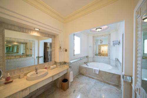 a large bathroom with a tub and a sink at Rajmahal Palace RAAS in Jaipur