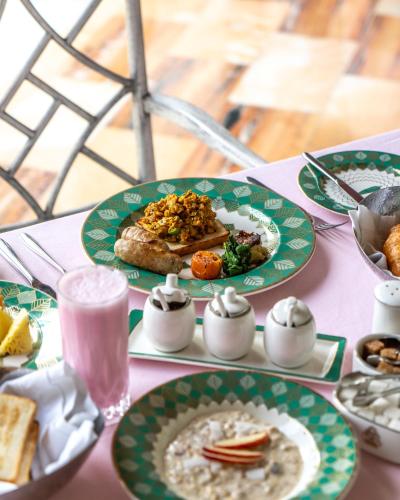 a table with plates of food on top of it at Rajmahal Palace RAAS in Jaipur