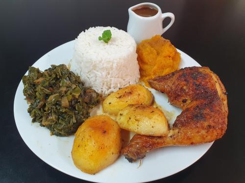 a plate of food with rice and vegetables and a cup of coffee at Lavender Lane in Ladysmith