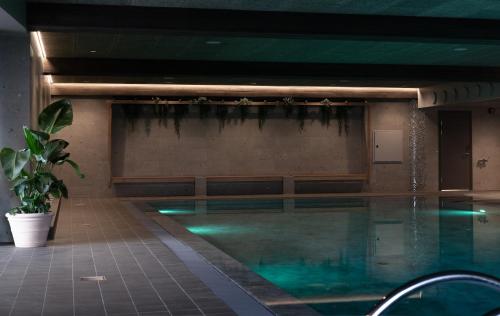 a swimming pool with green lighting in a building at Soria Moria Hotell in Oslo