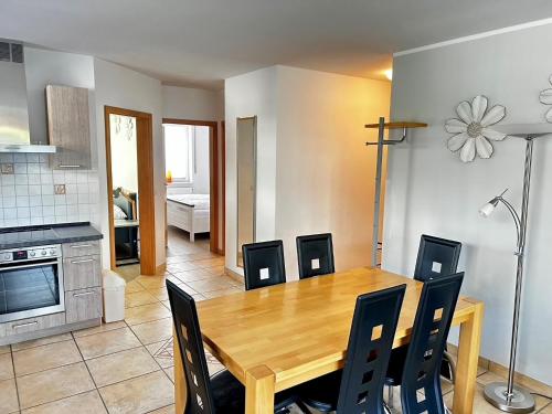 a kitchen and dining room with a wooden table and chairs at Birkenstraße 7 Whg 1 in Zingst
