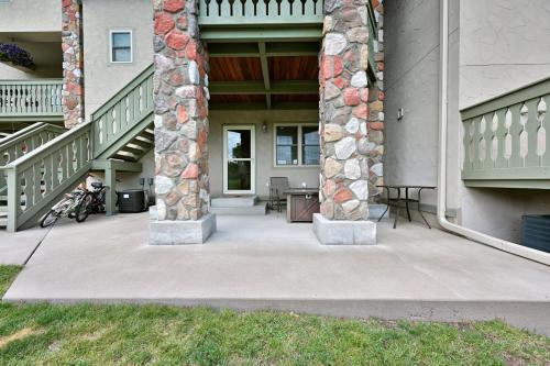 a porch of a house with two stone columns at Unit 109 2 BDRM 2 BA condo in Birchwood