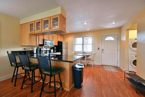 a kitchen with a counter and bar stools in it at Unit 109 2 BDRM 2 BA condo in Birchwood