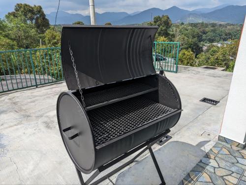 a black grill sitting on top of a roof at Villa with Titiwangsa Hill View in Kerling