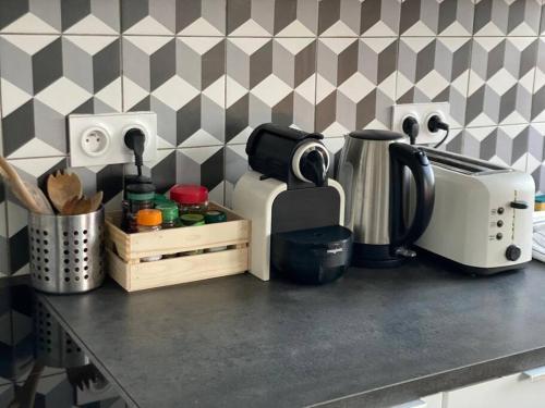 a kitchen counter with a coffee maker and a toaster at Charmant appartement quartier école d’agronomie in Montpellier