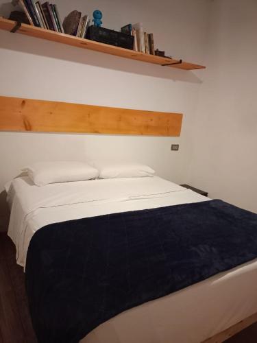 a bedroom with a white bed with a black blanket at Casa Azul in La Paz