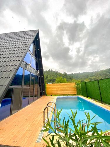 a swimming pool on the deck of a house at Lerik House in Lerik