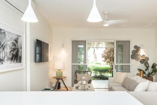 a living room with a couch and a table at "Beach Happy" Schooner Bay - Beachfront Apartment in Saint Peter