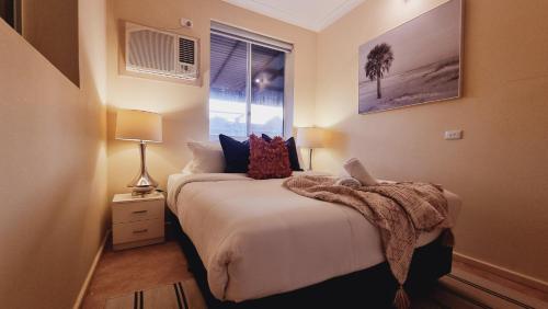 a bedroom with a bed with a blanket on it at Reel in Serenity - Peaceful Beach Fishing Awaits in Onslow