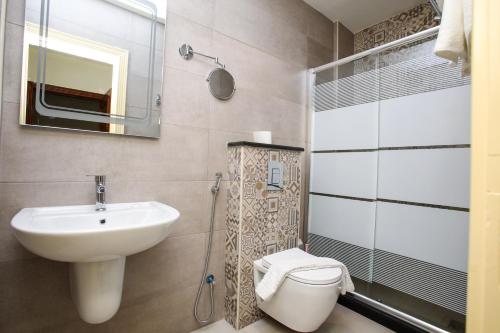 a bathroom with a sink and a toilet and a mirror at Al Sadrah View Hotel-فندق اطلالة السدرة in Aqaba