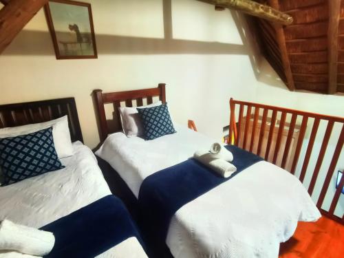 two twin beds sitting in a room with at Lipizzaner Lodge - Kyalami, Midrand in Kyalami