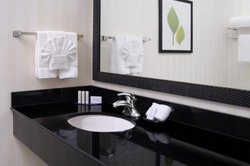 a bathroom with a black sink and a mirror at Fairfield Inn & Suites by Marriott Dallas Plano The Colony in The Colony