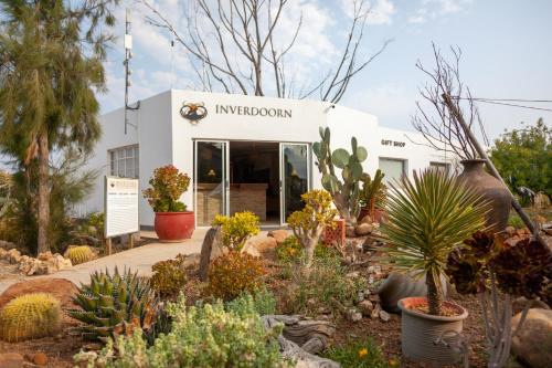 a garden in front of a building with plants at Inverdoorn Game Reserve Lodge in Breede River DC