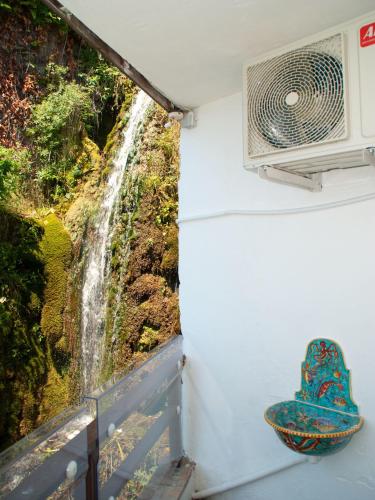a view of a waterfall from a room with a fan at Il Nido del Gabbiano in Vietri sul Mare