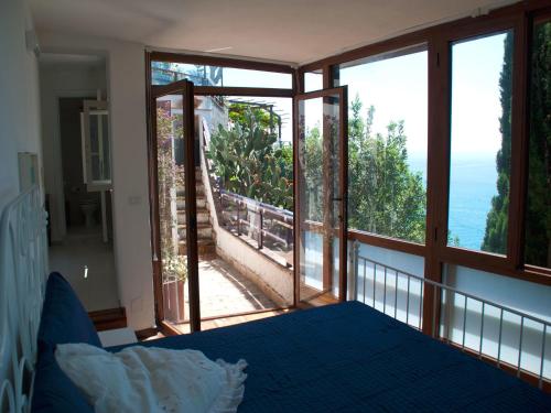 a bedroom with a bed and a view of the ocean at Il Nido del Gabbiano in Vietri sul Mare