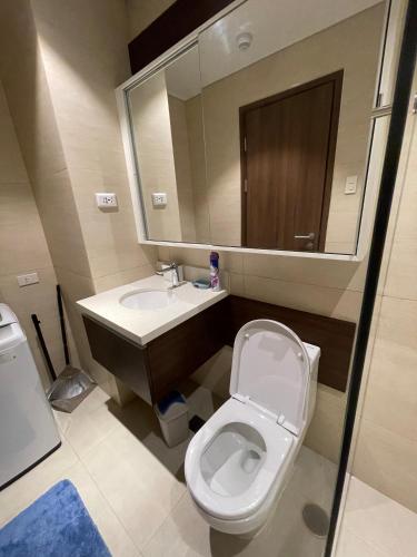 a bathroom with a toilet and a sink and a mirror at Ma Roberta @ Tambuli Resort with fast WIFI in Maribago