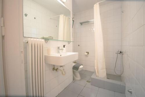 a bathroom with a sink and a shower and a toilet at Chic Kastella Apt by Mikrolimano in Piraeus