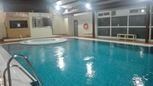 a large swimming pool in a building at Apartamentos Sueño Nevado con Piscina a pie de Telesilla in Sierra Nevada