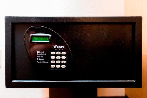 a microwave oven with a clock on top of it at Red Roof Inn Tampa Fairgrounds - Casino in Tampa