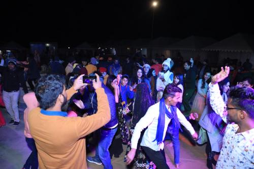 a crowd of people dancing at a party at Melody Moon Desert Camp & Resort in Jaisalmer